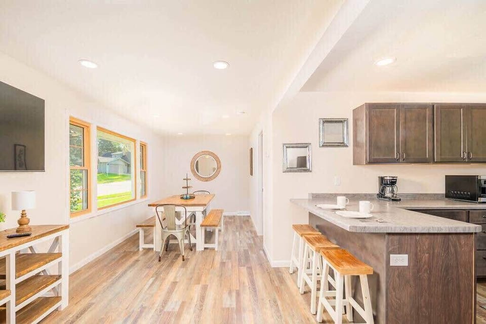 The kitchen is open to the dining area which comfortably seats 6. The island can seat 3. The kitchen is also open into the living area where you can see the smart tv featured on the wall. 