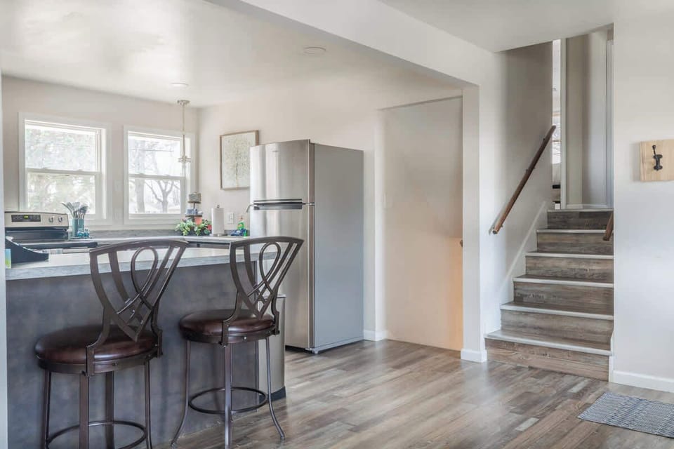 Enjoy the spacious kitchen, perfect for preparing meals, with easy access to both the living room below and the bedrooms upstairs. The dual staircases provide a seamless flow, making it easy to move between areas of the home.