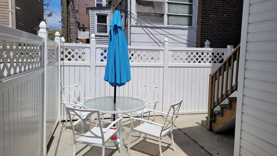 Backyard w/ Umbrella-Covered Seating for 4