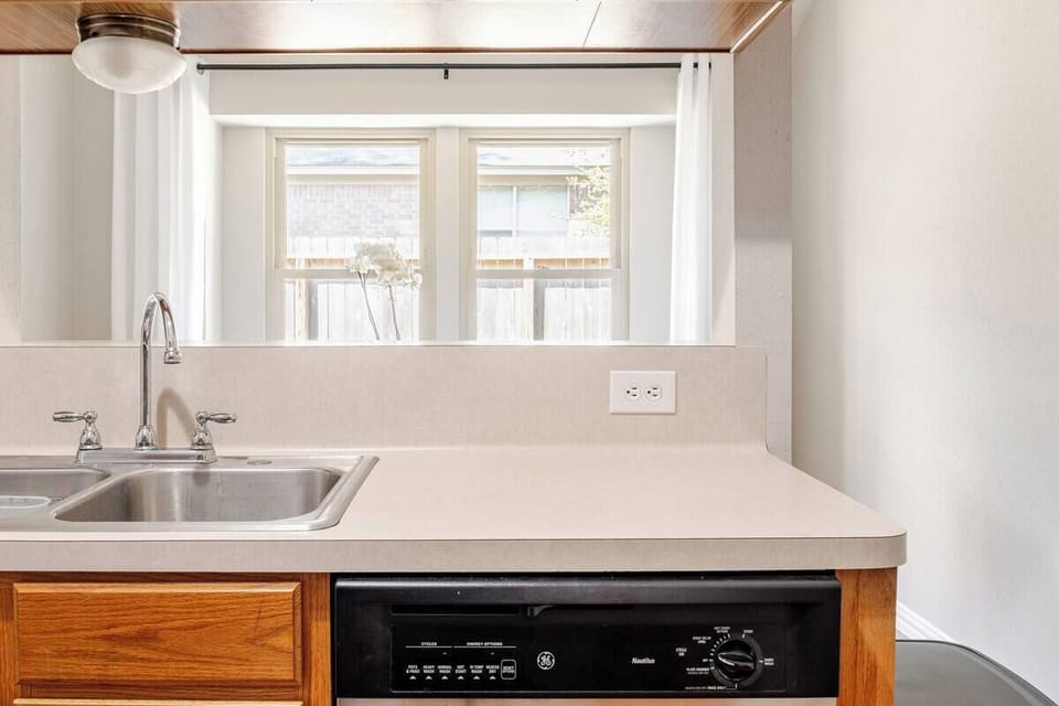 Kitchen featuring a gas stove, large stainless steel fridge & the essentials.