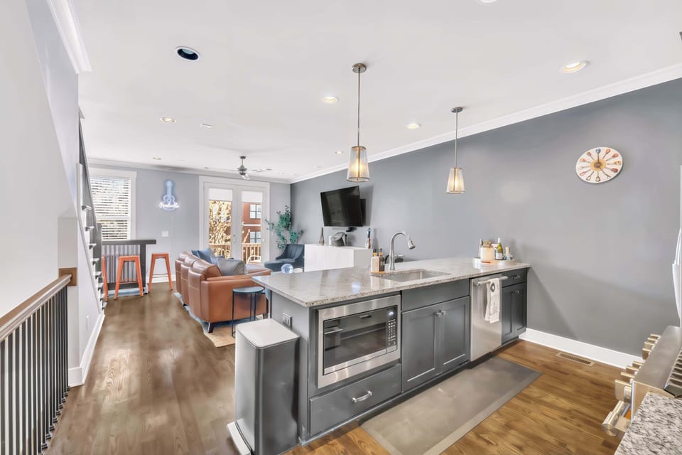 Enjoy stylish Nashville living in this chic vacation rental! Ideal for large groups, it features an open layout and luxury amenities for your downtown adventures or bachelorette party. Experience the vibrant atmosphere of Music City in your upscale retreat!