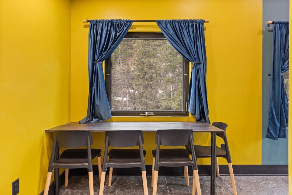 Gather around the cozy dining table that comfortably seats four, perfect for enjoying home-cooked meals, morning coffee, or game nights. T