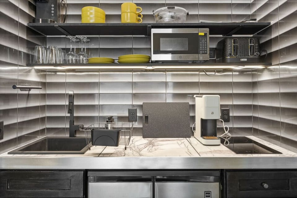 The microwave and induction stove provide easy cooking options, while the mini fridge keeps your ingredients fresh