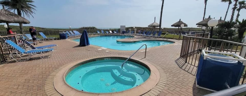 Relaxed poolside setting with a calm coastal vibe—bright water, open space, an easy flow that invites guests to unwind at their own pace. A naturally welcoming spot that feels genuine and unforced without relying on amenities to define the experience