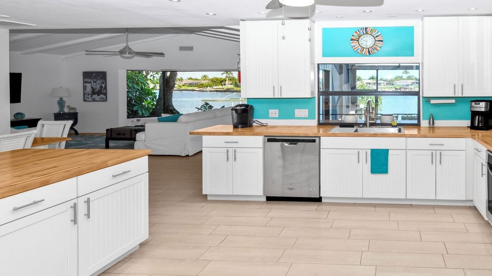 The spacious kitchen includes a pass-through window to the patio