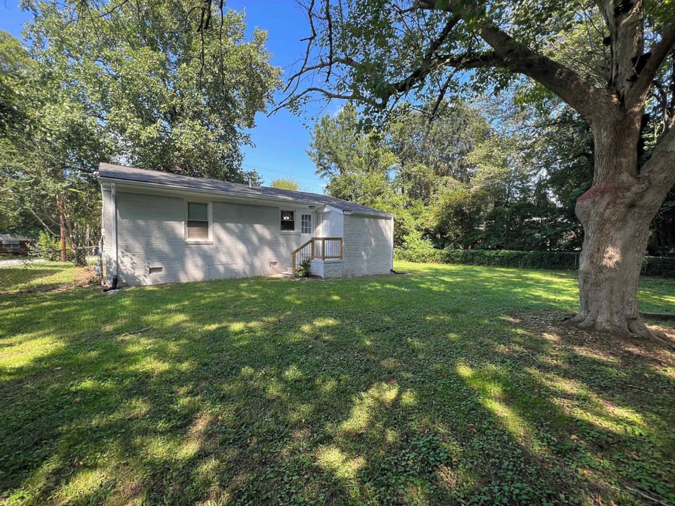 Enjoy a spacious backyard surrounded by mature trees and open green space. This peaceful outdoor area offers room to relax, play, or unwind in nature, making it a refreshing retreat during your stay.