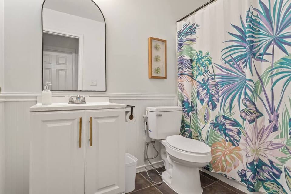 View of hall bath with tub shower.