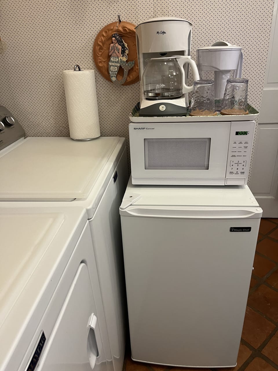 Kitchenette area with microwave, refrigerator, coffee maker, and utensils