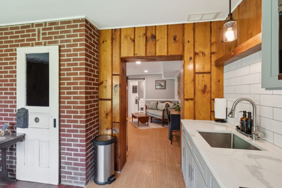 Kitchen corner w/ brick accent wall & double sink for easy prep
