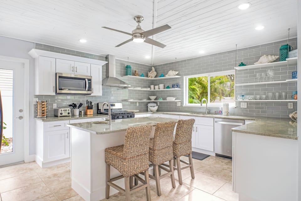 Bright breezy kitchen—fully stocked & stylish for beachside bites.