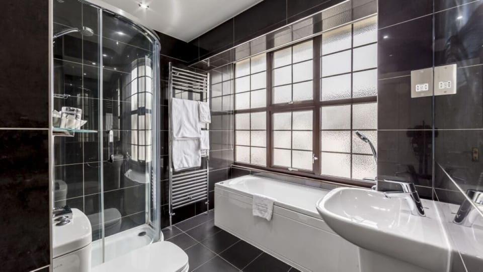 Unwind with a soothing soak after a steamy glass shower.