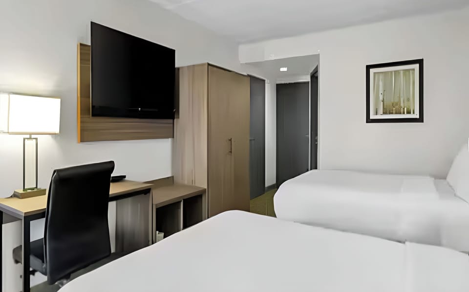 Relax together with roomy beds, desk, and bright lamps.