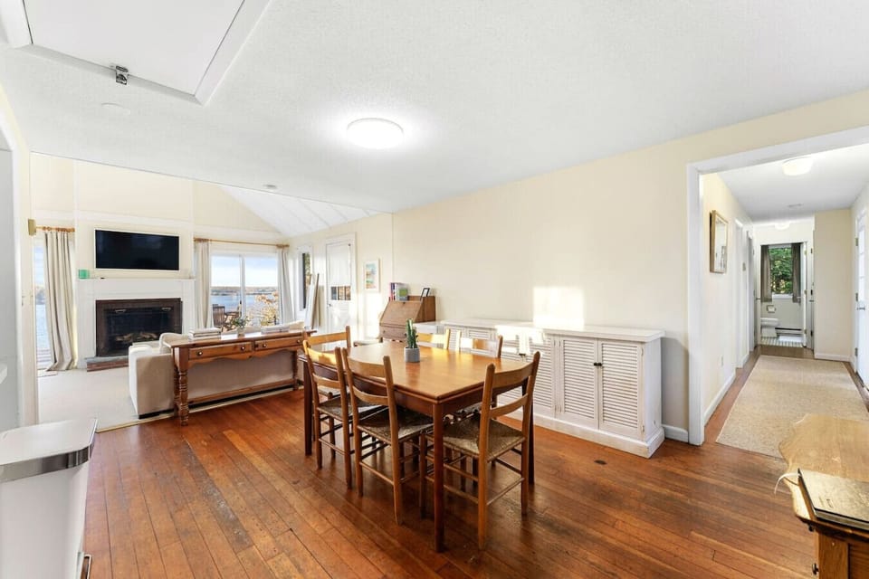 Envision yourself enjoying meals in our bright and airy dining area, just steps from the living room. The large dining table, comfortable chairs, and a beautiful plant centerpiece create the perfect setting for relaxed gatherings and memorable moments.