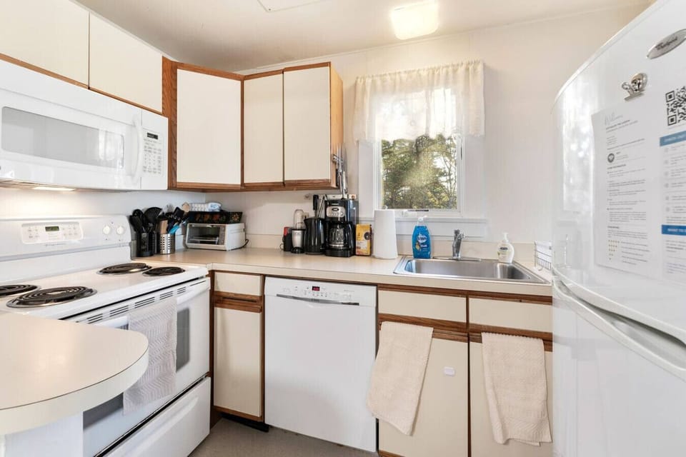 Wake up to the aroma of freshly brewed coffee from our coffee maker, and later, relax with a glass of wine from our wine glasses. Our kitchen is well-stocked with everything you need to prepare meals—a stove, oven, microwave, dishwasher, and all the utens