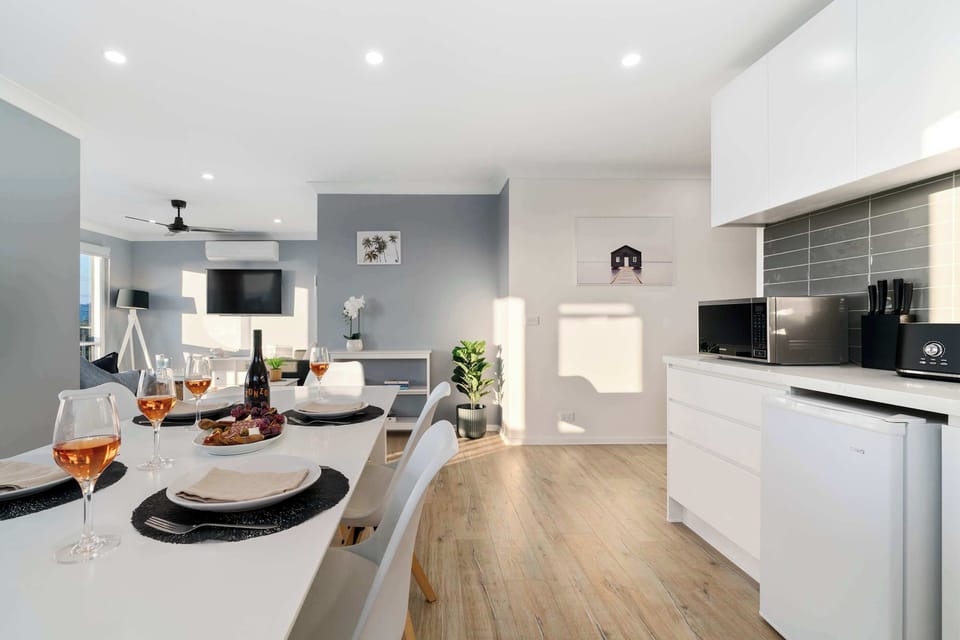 The upstairs open living area, including a second kitchenette with microwave, toaster, kettle, bar fridge and sink