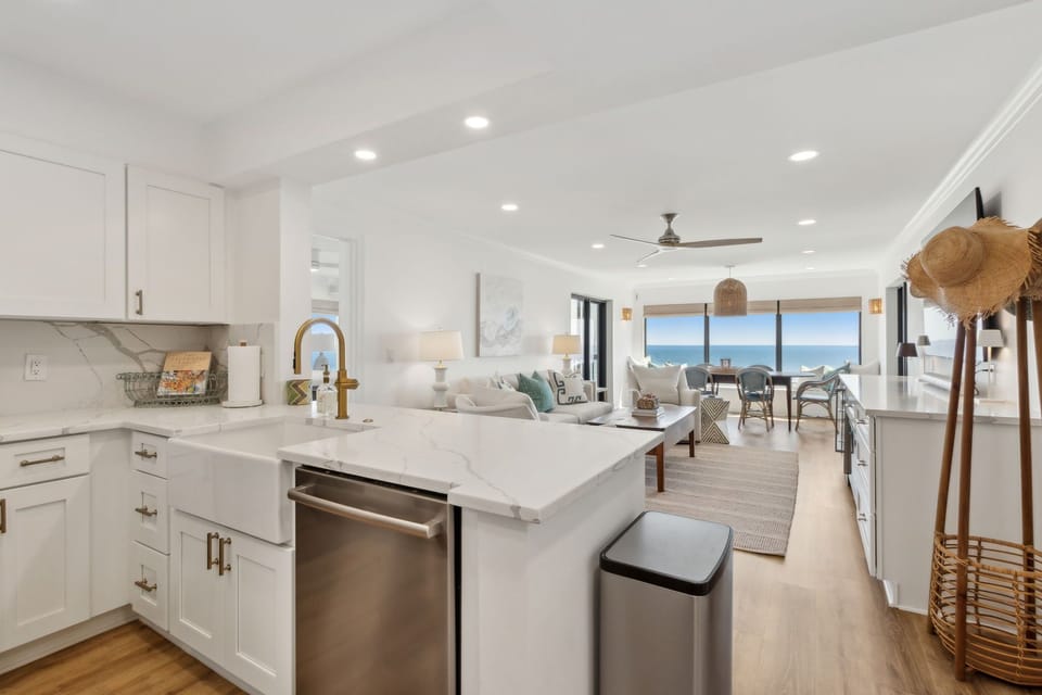 Updated Kitchen with Quartz Countertops, Stainless Steel Appliances, and Large Farmhouse Style Sink