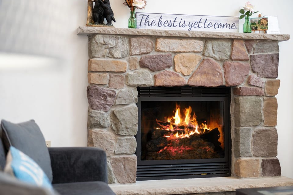 Warm your toes by the crackling fire in the handsome stone fireplace