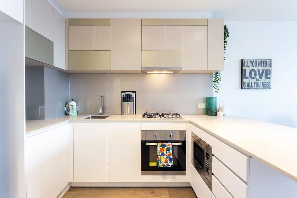 Kitchen with oven, gas stove, microwave , fridge , dishwasher and washing machine and dryer 