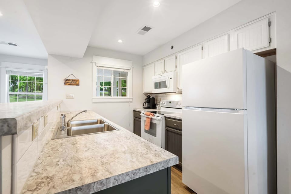 The open, airy kitchen offers ample space & every home comfort