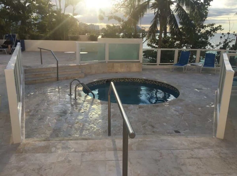 Hot Tub Area – Unwind with ocean views and sunset vibes in this cozy beachfront jacuzzi spot.