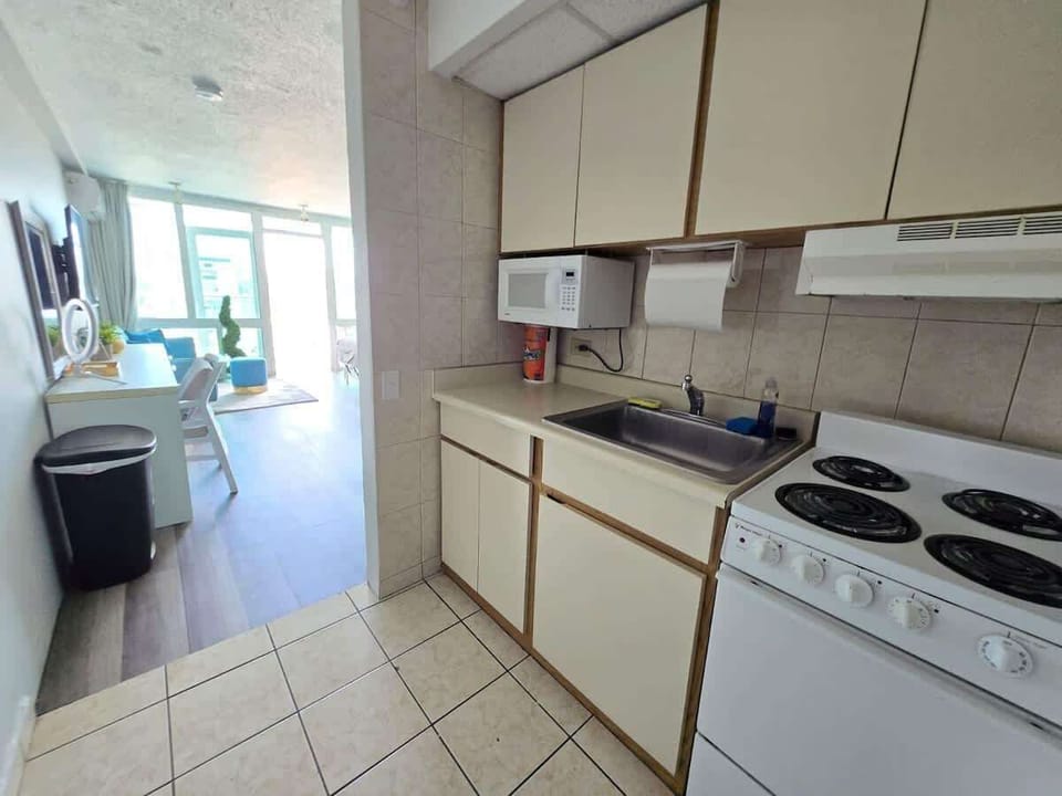 Kitchen – Enjoy a functional kitchen setup with direct access to a bright and stylish living space, perfect for casual cooking or quick bites before the beach.
