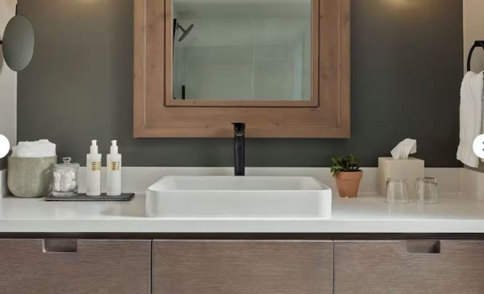 Start the day at a sleek vanity with warm ambient lighting.