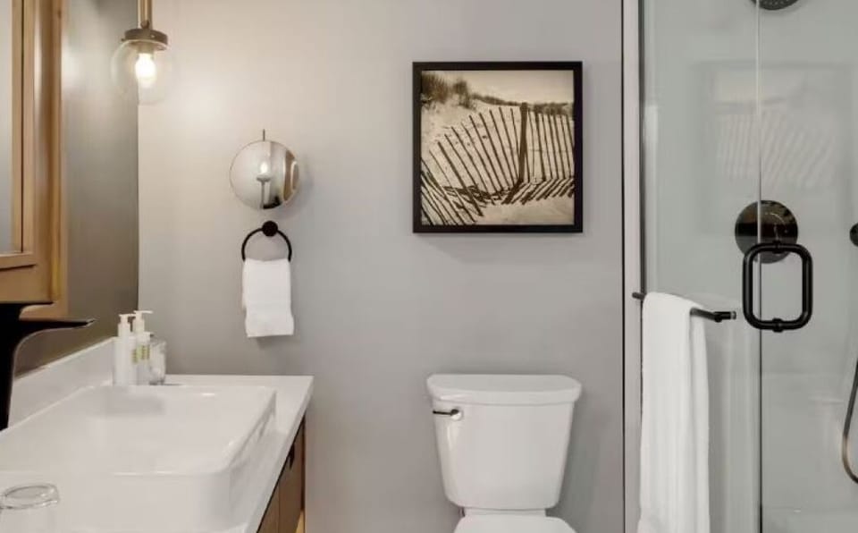 Freshen up in a spotless bathroom with a glass walk-in shower.