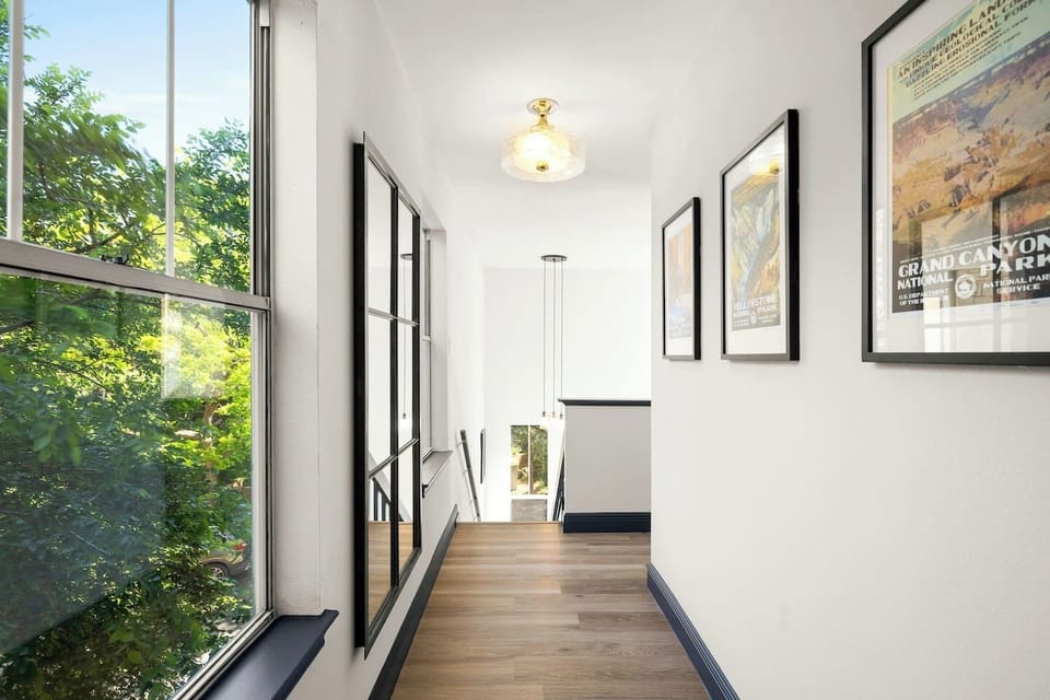 The well-lit walkway that leads to both bedrooms.