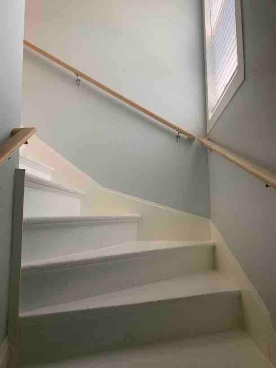 Stairs in common hallway to upstairs unit