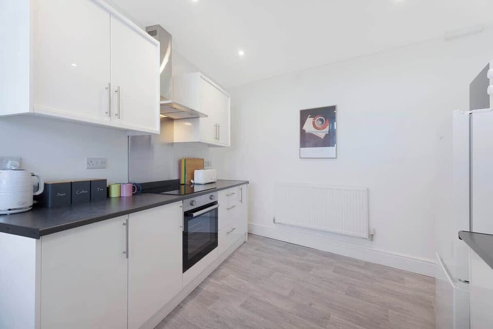 Kitchen equipped with all essentials, including a washer & dryer, oven, fridge and full cookware set.