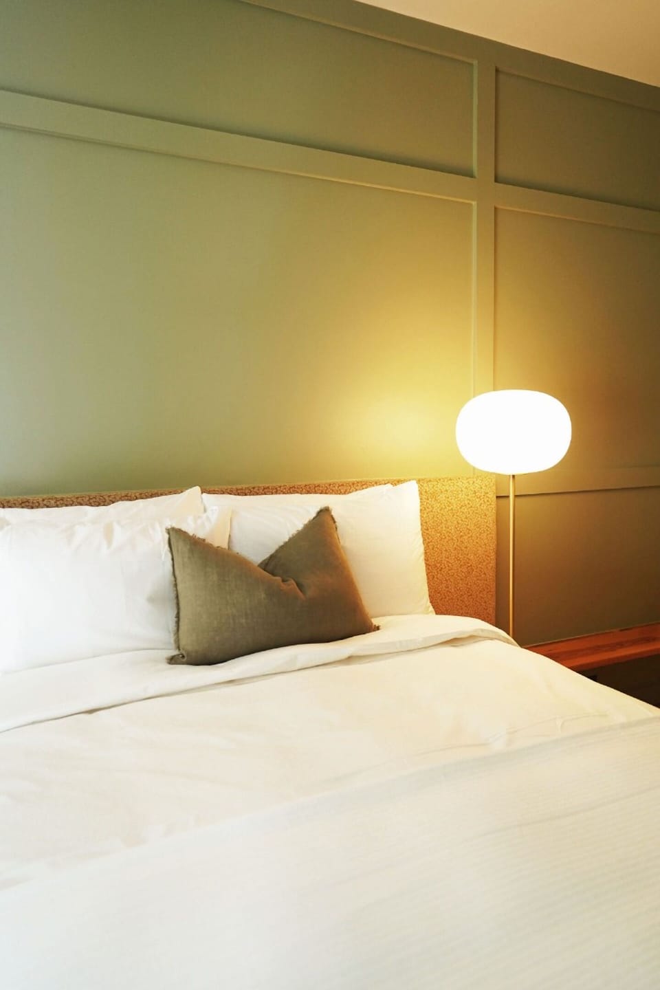 Relax beside soft glow lighting and beautifully layered bedding.