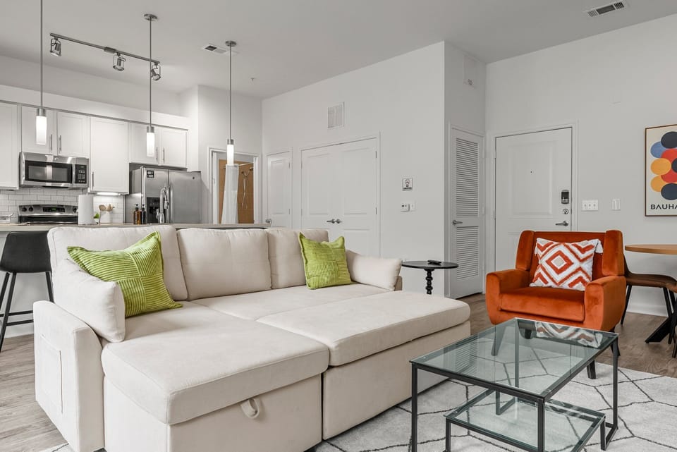 Modern living room features a sectional queen sized sofa bed, 65"smart TV & more