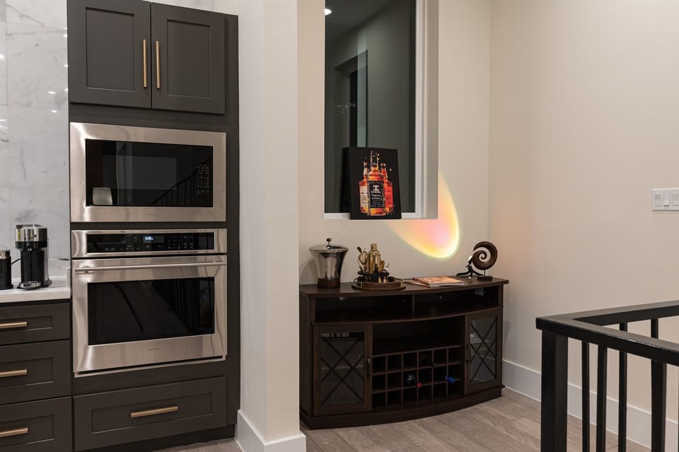 A kitchen with a built-in Monogram oven and microwave. 