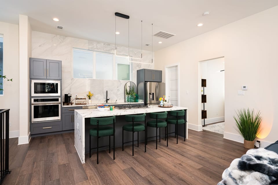 Gourmet kitchen with oversized island, luxe finishes, and seating for six — made for entertaining.