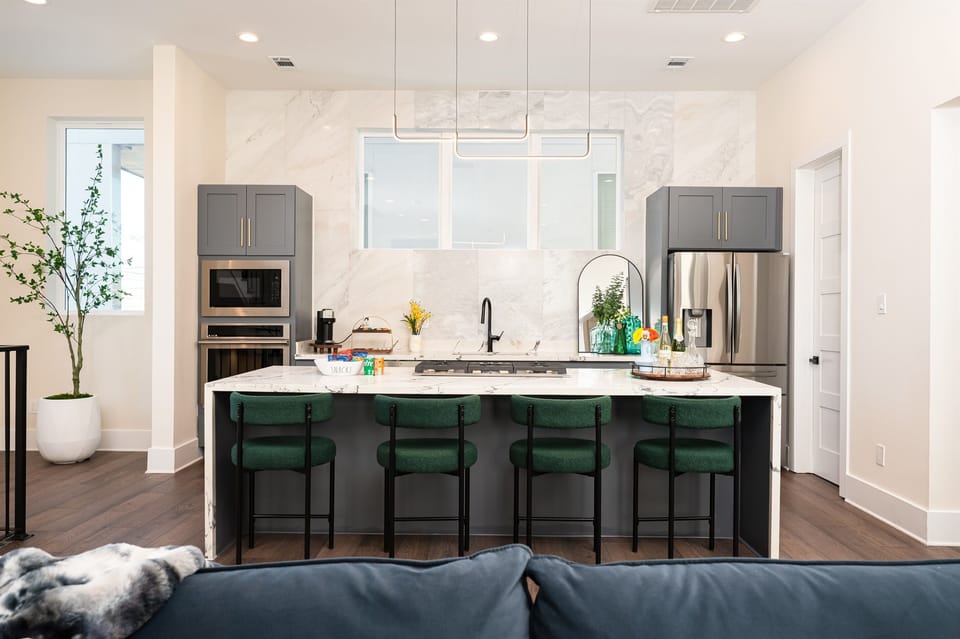 Cook in style with marble finishes, chef-grade appliances, and island seating for four.
