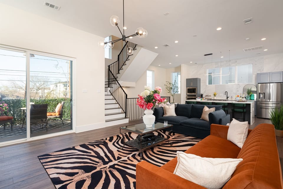 Enjoy a stylish, sunlit living area with bold décor, perfect for relaxing or entertaining.