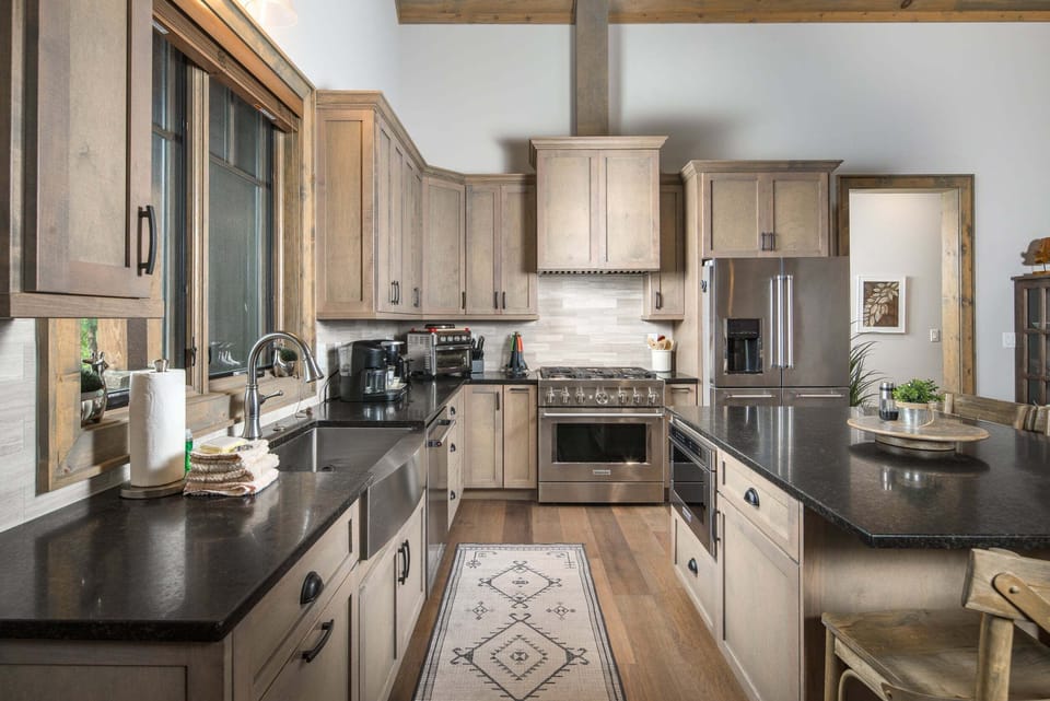Kitchen with stainless steel appliances, ample cabinetry, and generous counter space