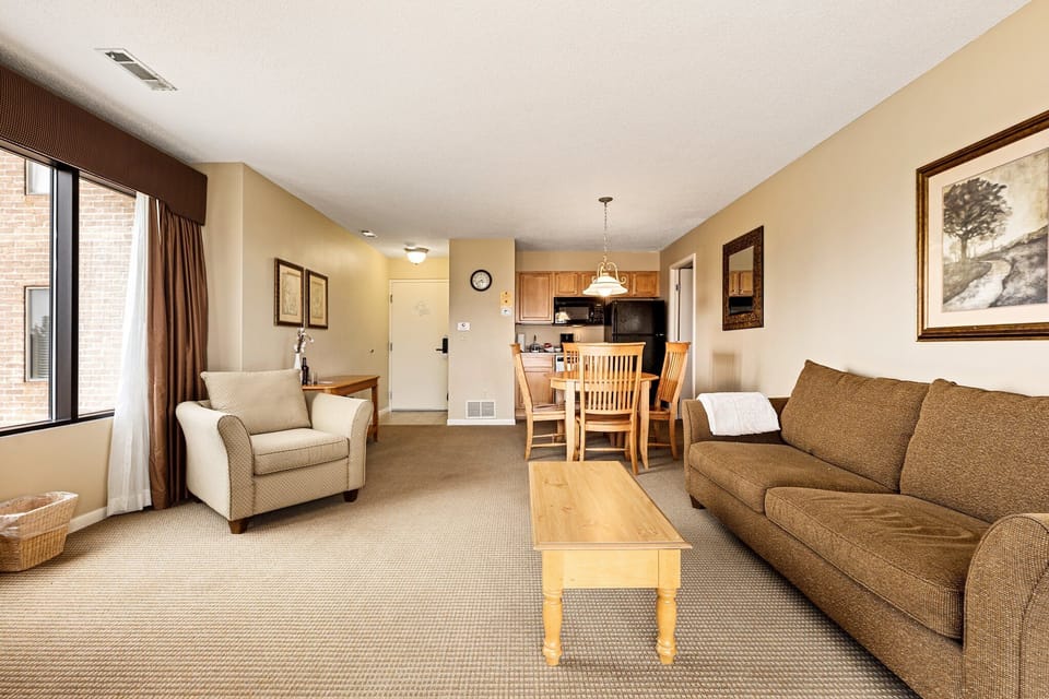 Open living space w/ comfy seating, dining table & bright natural light.