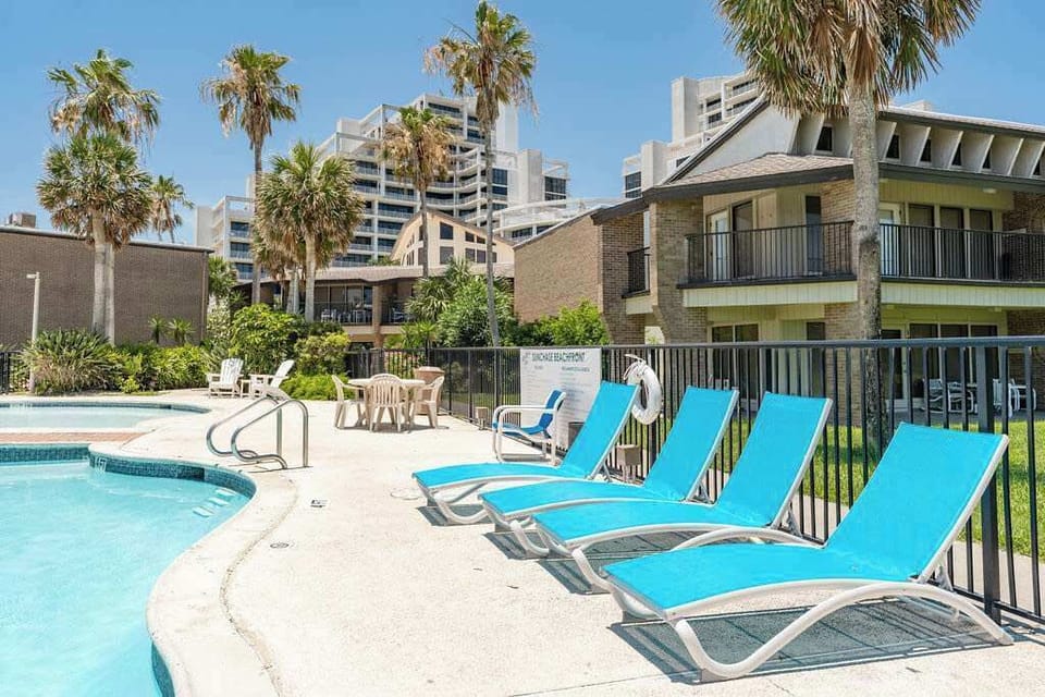 Soak up the sun poolside at Sunchase with palm views.