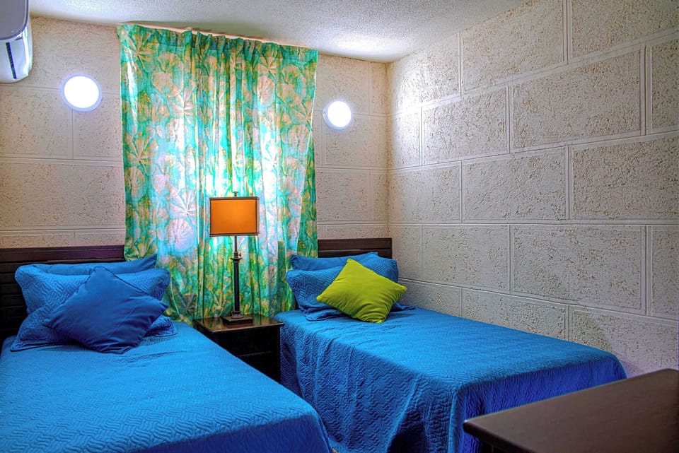 Two comfy twin beds await your arrival.