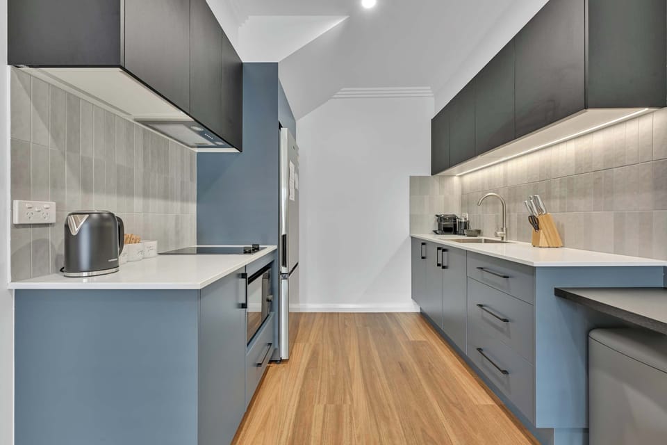 The kitchen features ample storage for longer stays, along with a cooktop, combination microwave, and more.