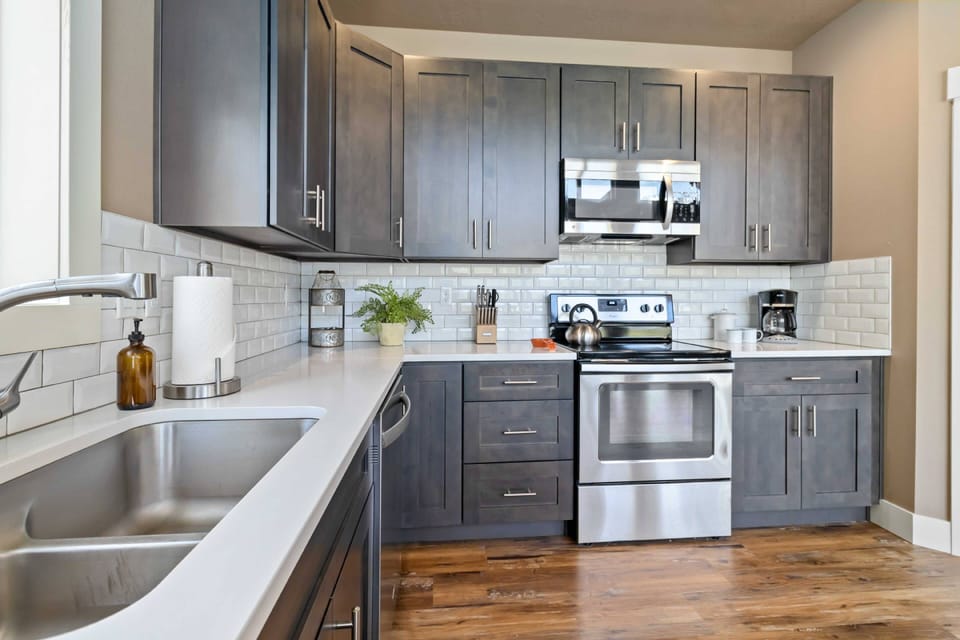 Fully-equipped kitchen with stainless appliances and quartz countertops