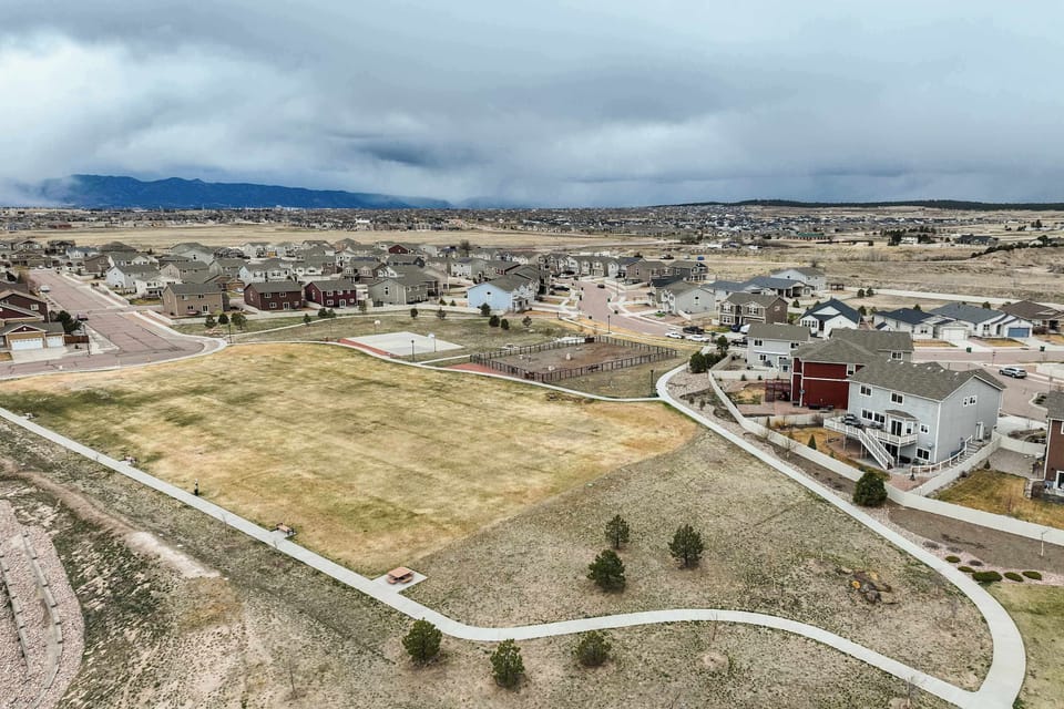 This aerial view showcases the peaceful residential neighborhood with nearby parks and walking trails. The property is conveniently located within a family-friendly community.






