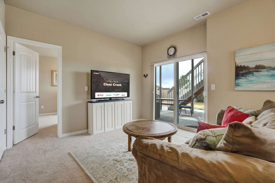 Welcome to Clear Creek! Relax in the comfortable living area, complete with cozy seating, a Smart TV, and a dining space with scenic window views.







