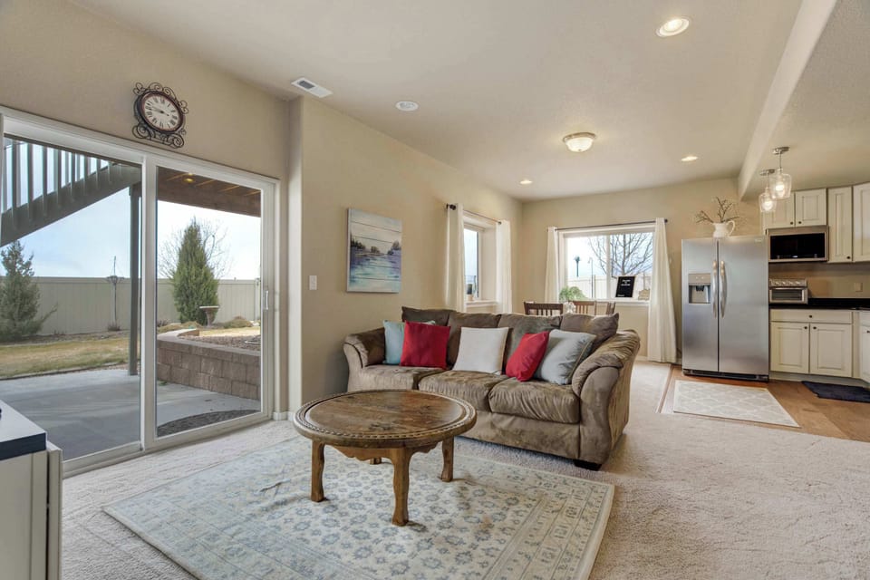 Cozy living area with a comfortable sofa, coffee table, and easy access to the private backyard through sliding glass doors. Perfect for relaxing or enjoying the outdoor space.






