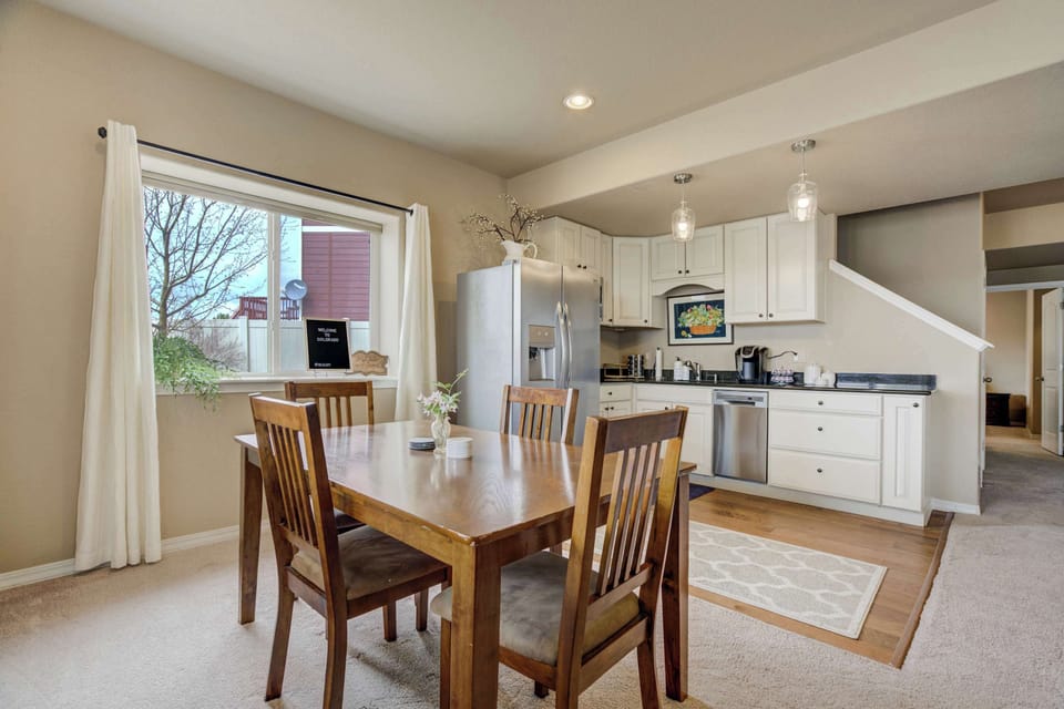 Inviting dining area seamlessly connected to the fully equipped kitchen, perfect for shared meals and gatherings. Large windows add plenty of natural light.






