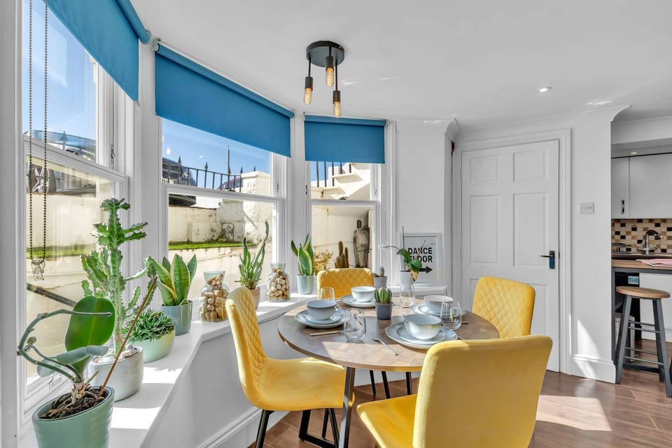 Bright and airy living area with modern furnishings and natural light from large windows.