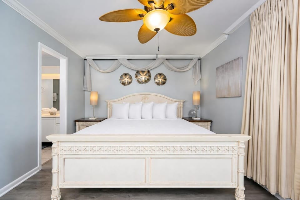Calm colors and gentle lighting create a serene retreat in the master suite with a king bed