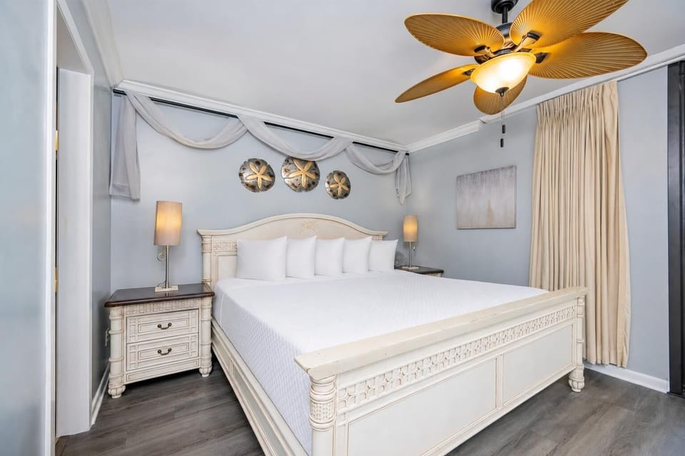 King bed in the master suite invites restful nights beneath the tropical ceiling fan's gentle hum