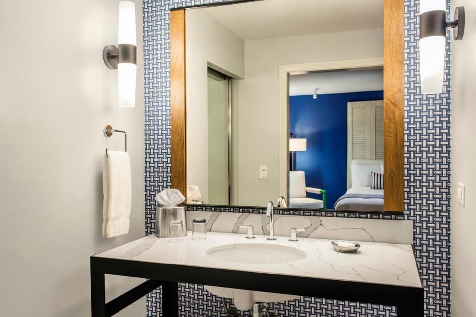 Refresh each morning at the sleek vanity with bright lighting.